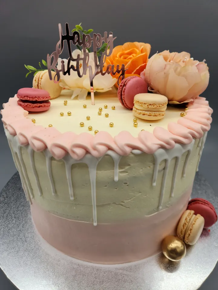Pink and cream drip birthday cake with macarons