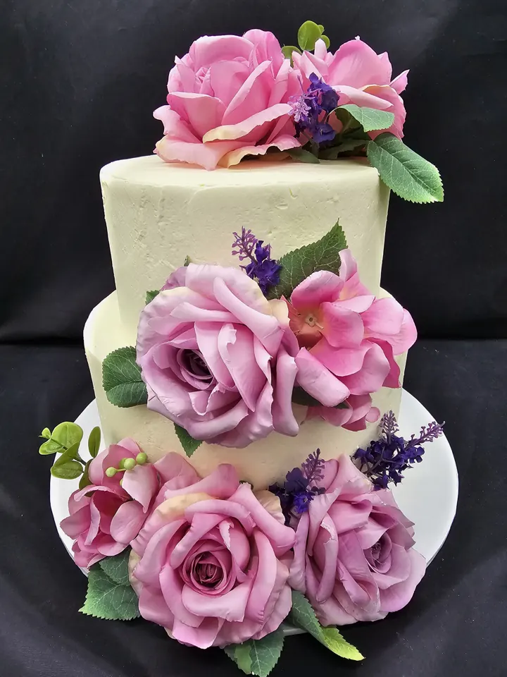 Three-tier wedding cake with fresh roses