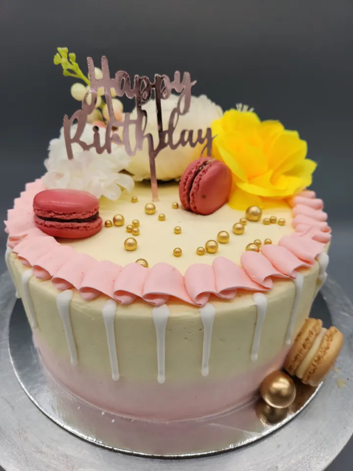 Cream drip birthday cake with yellow flowers