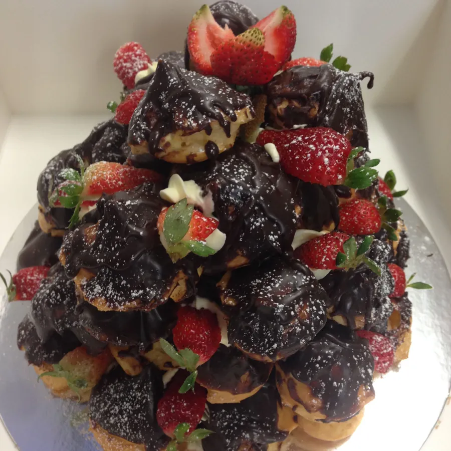 Profiterole Tower of cream-filled profiteroles finished with chocolate