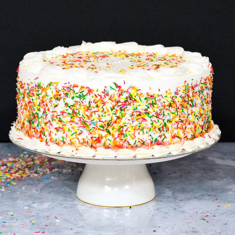 Rainbow Torte with colourful rainbow sponge layers and cream
